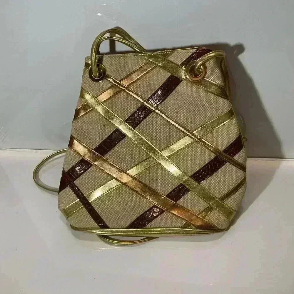 Moda Attiva gold, leather strips, and fabric crossbody bag
